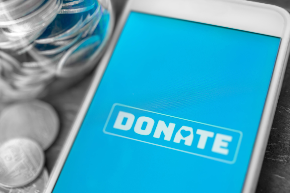 2022 Charitable Giving Trends, image of a cell phone with the word "donate"